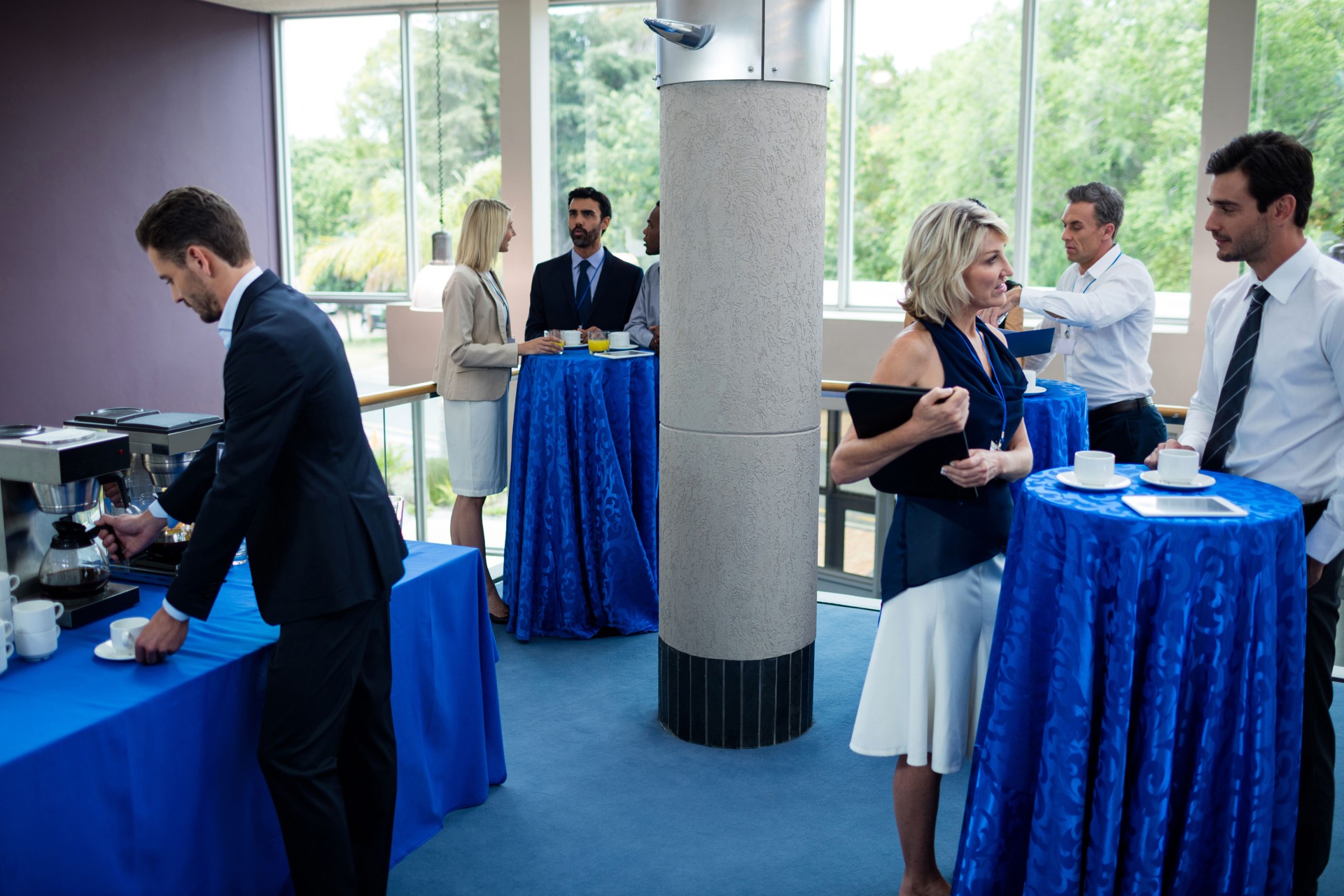 Business executive taking coffee from coffee maker